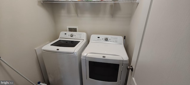 washroom featuring washing machine and dryer