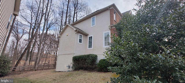 view of side of property with a lawn