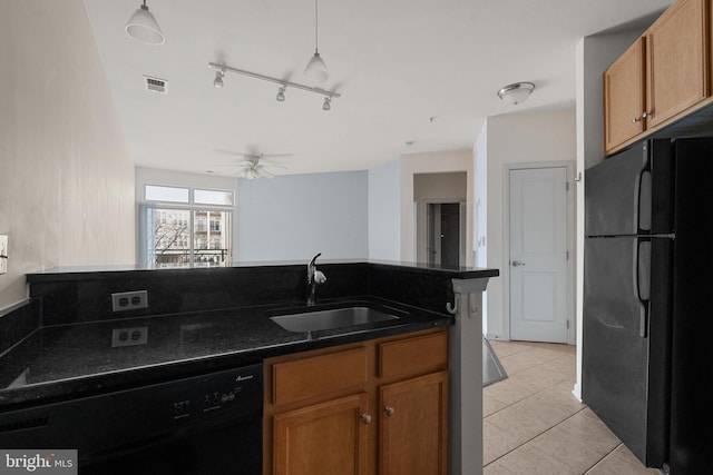 kitchen with black appliances, a sink, visible vents, and brown cabinets