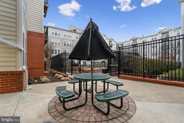 view of patio / terrace featuring a residential view and fence