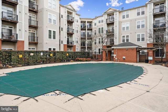 view of swimming pool with fence