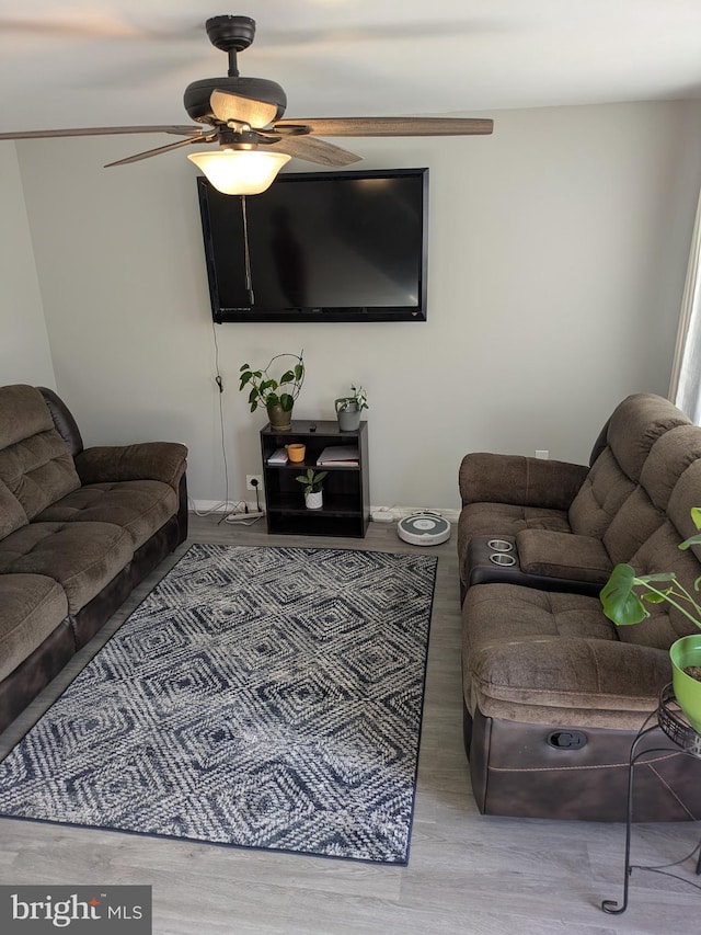 living room with hardwood / wood-style flooring and ceiling fan