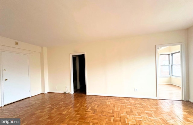 spare room with light parquet flooring