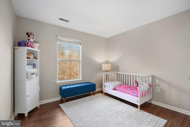 bedroom with dark hardwood / wood-style flooring