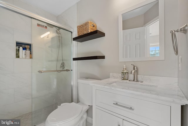 bathroom with vanity, an enclosed shower, and toilet