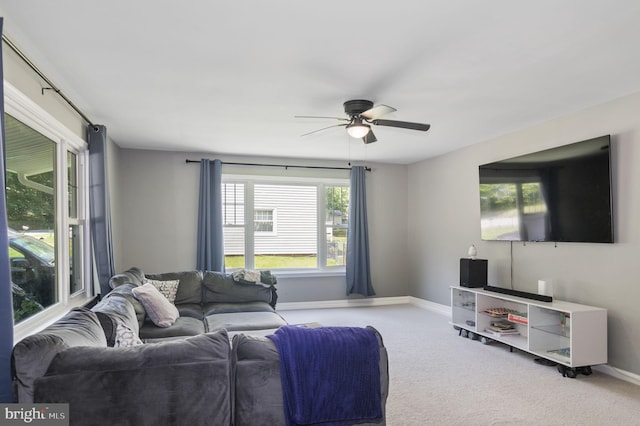 living room with light colored carpet and ceiling fan