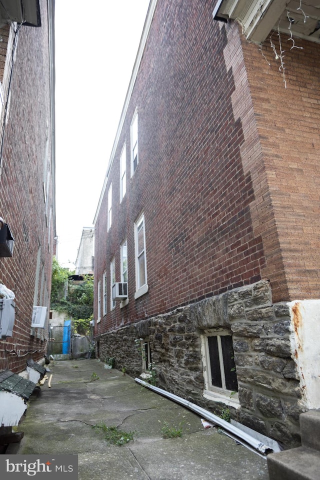 view of property exterior featuring cooling unit and a patio area