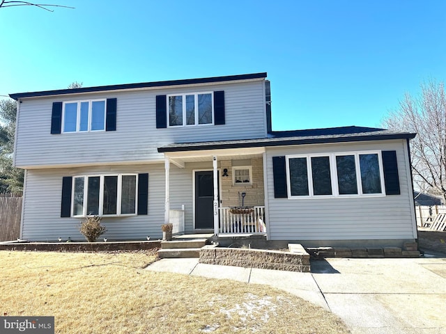 front of property with a porch and a front lawn