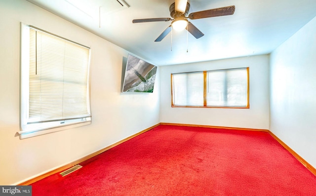 carpeted spare room with ceiling fan