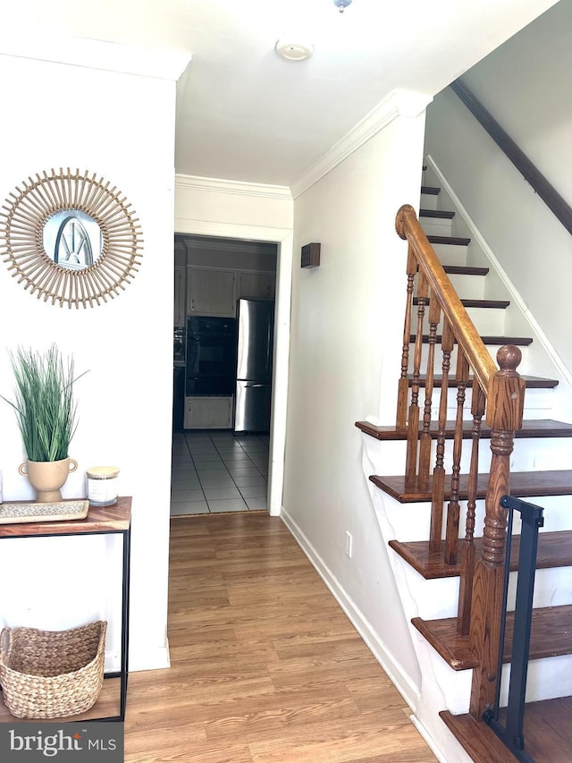 interior space with hardwood / wood-style flooring and ornamental molding