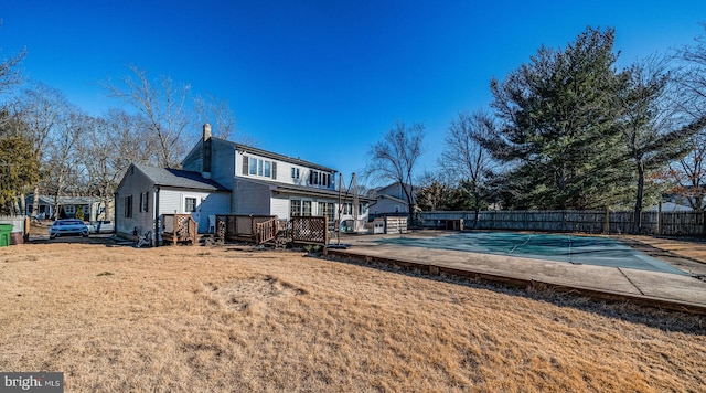 exterior space with a wooden deck and a lawn