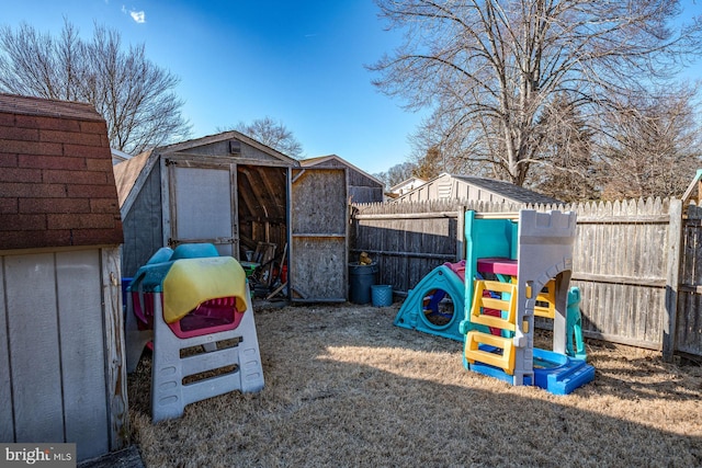 view of jungle gym featuring a storage unit