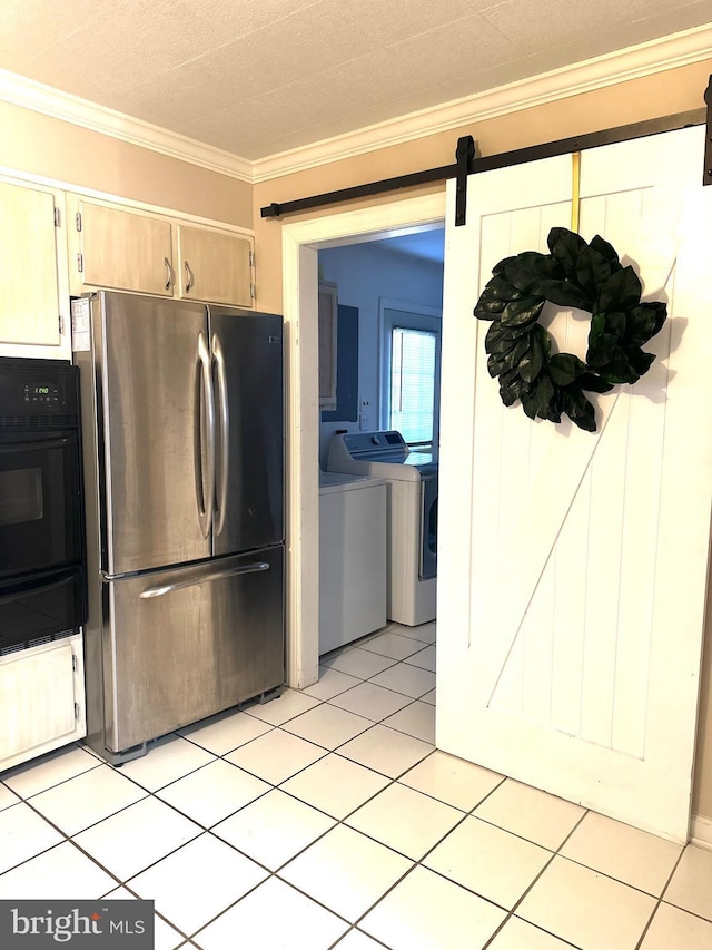 kitchen featuring black oven, stainless steel fridge, independent washer and dryer, crown molding, and a barn door