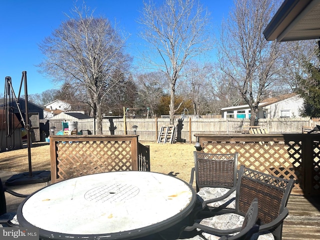 wooden terrace with a playground