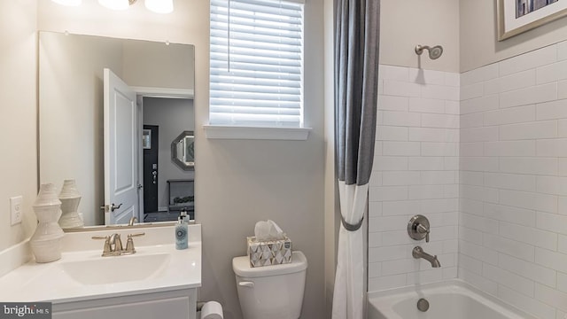 full bathroom with vanity, shower / bath combination with curtain, and toilet