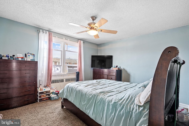 carpeted bedroom featuring cooling unit, ceiling fan, radiator, and a textured ceiling