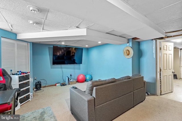 living room with a paneled ceiling and light carpet