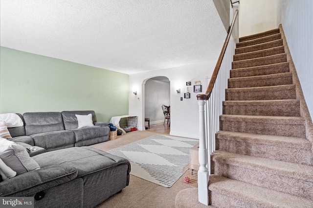 carpeted living room with a textured ceiling