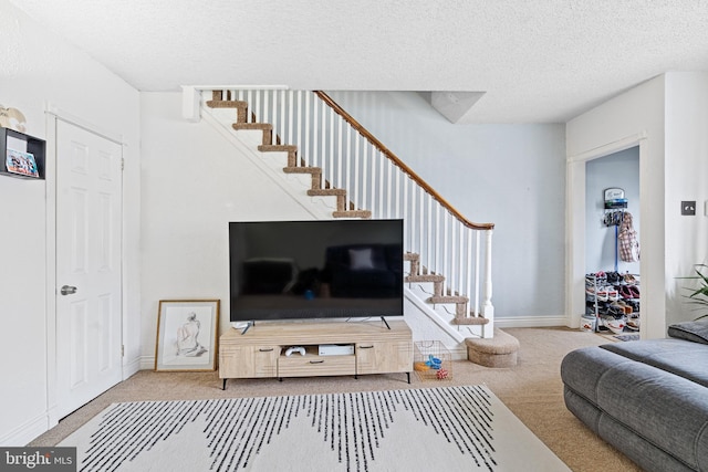 carpeted living room featuring a textured ceiling