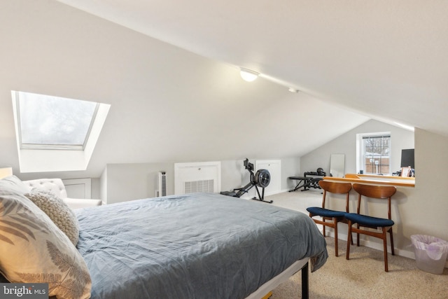 carpeted bedroom with lofted ceiling with skylight