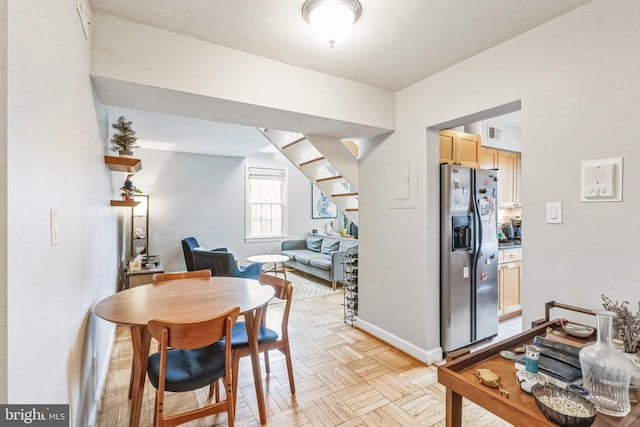 dining space featuring light parquet floors