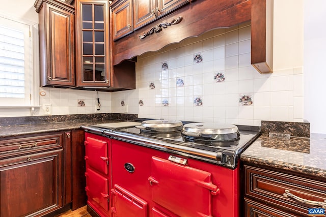 kitchen featuring cooktop, dark stone countertops, and decorative backsplash