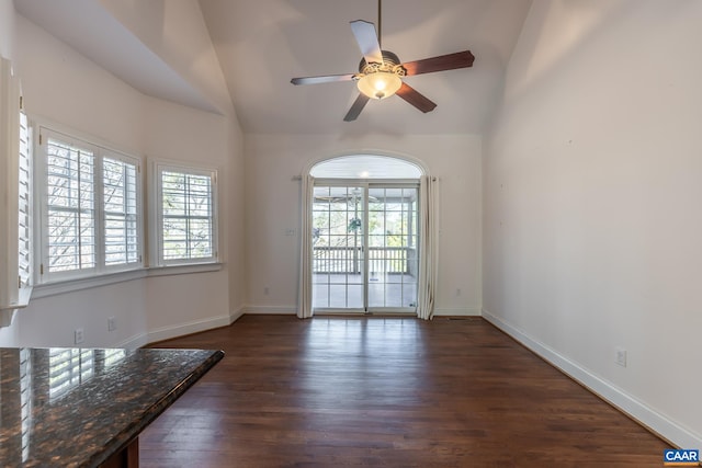 spare room with lofted ceiling, dark wood-type flooring, and ceiling fan