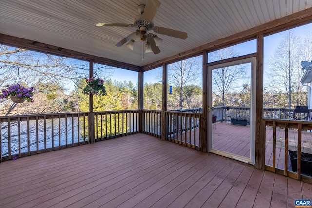 unfurnished sunroom featuring ceiling fan