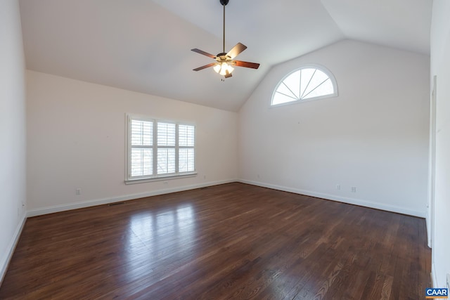 spare room with dark wood-type flooring, ceiling fan, and vaulted ceiling