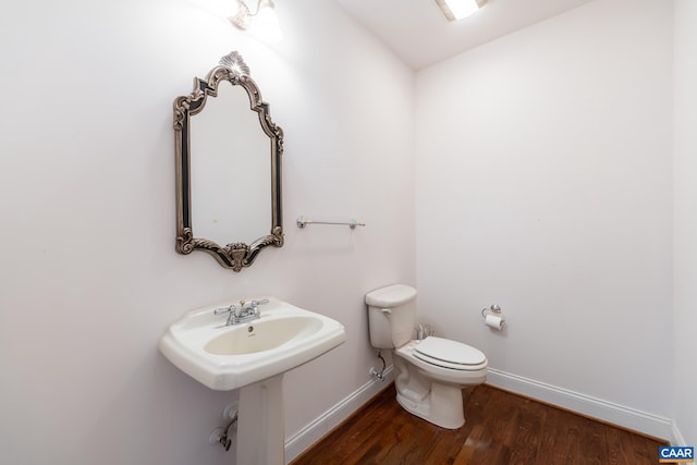 bathroom with sink, wood-type flooring, and toilet