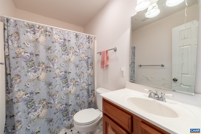 bathroom featuring vanity, curtained shower, and toilet