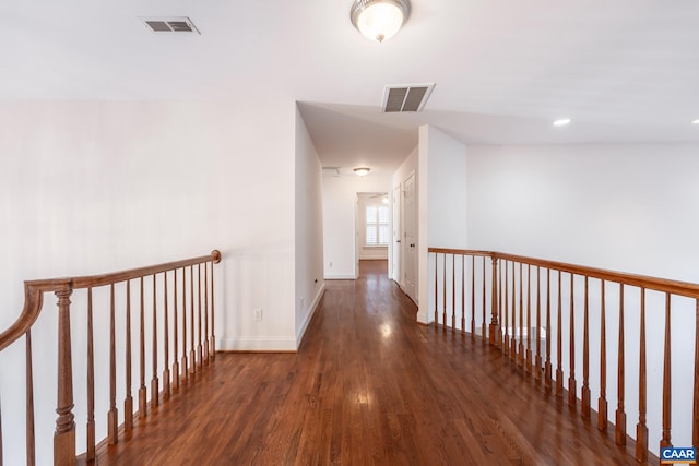 corridor with dark hardwood / wood-style flooring