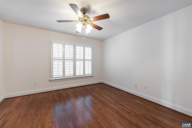 empty room featuring dark wood-type flooring and ceiling fan