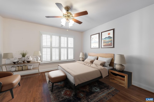 bedroom with dark hardwood / wood-style flooring and ceiling fan