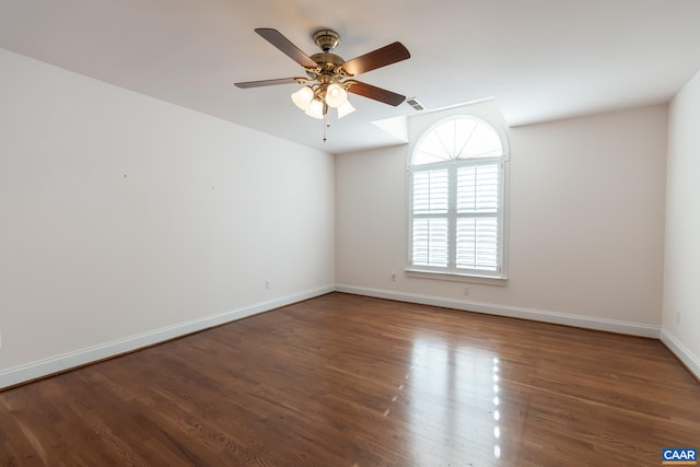 spare room with ceiling fan and dark hardwood / wood-style flooring