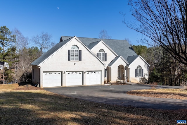 view of front property with a garage and a front yard