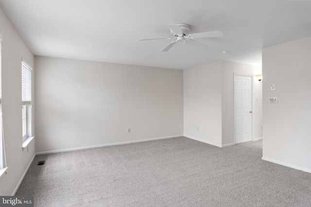 empty room featuring ceiling fan and carpet floors