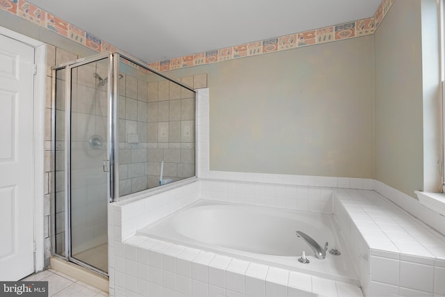 bathroom featuring plus walk in shower and tile patterned floors