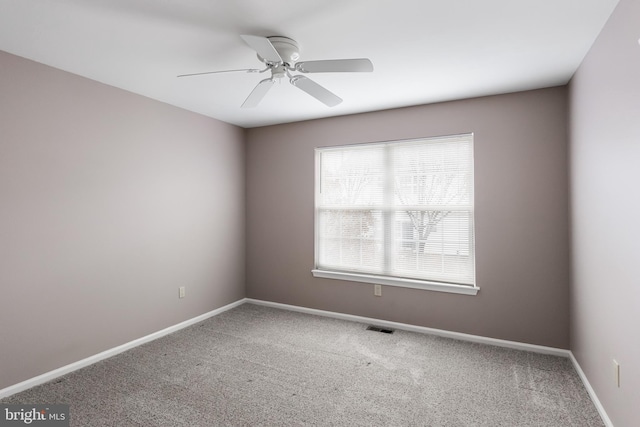 unfurnished room with ceiling fan and carpet flooring