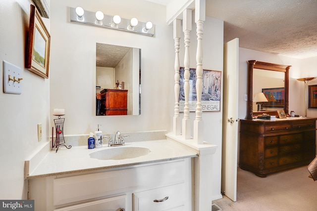 bathroom with vanity and a textured ceiling