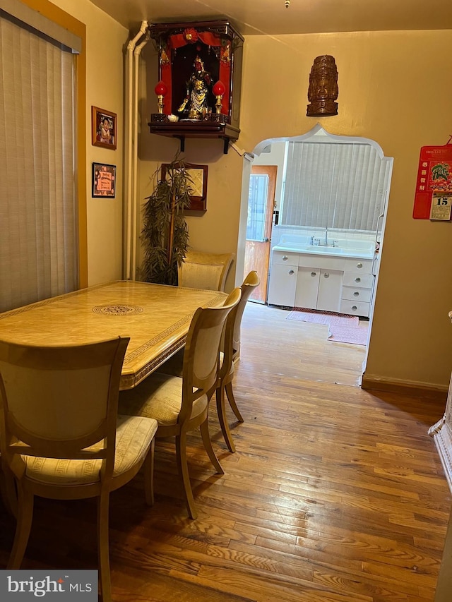 dining room featuring hardwood / wood-style floors and sink