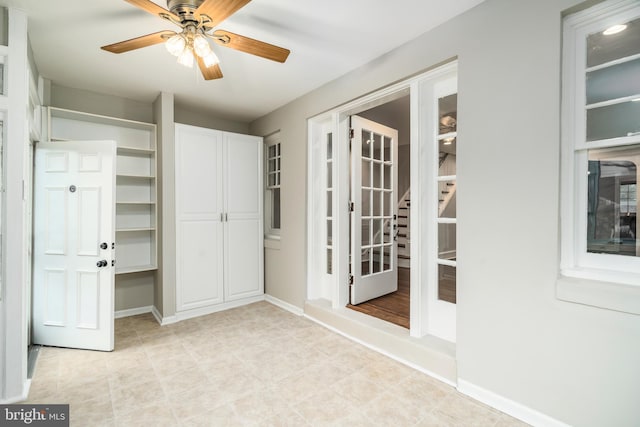 interior space with french doors and ceiling fan