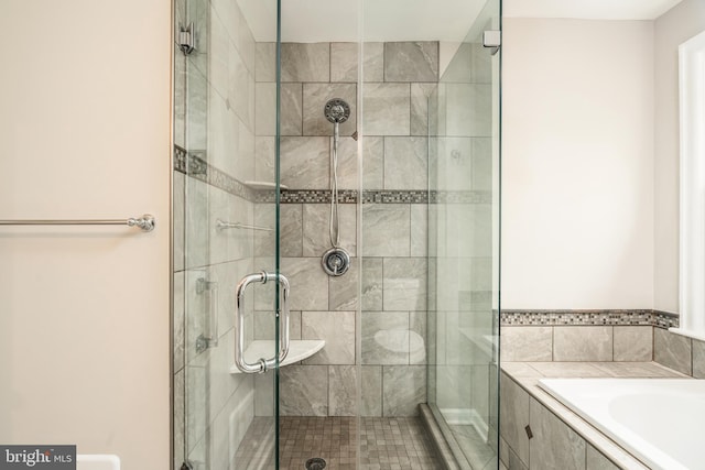 bathroom with shower with separate bathtub