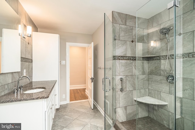 bathroom with tasteful backsplash, vanity, and an enclosed shower