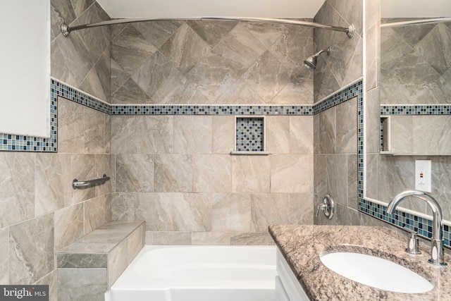 bathroom featuring vanity and tiled shower / bath combo