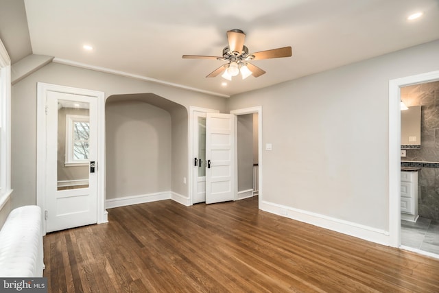 spare room with ceiling fan, radiator, and dark hardwood / wood-style flooring