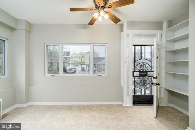 foyer entrance featuring ceiling fan