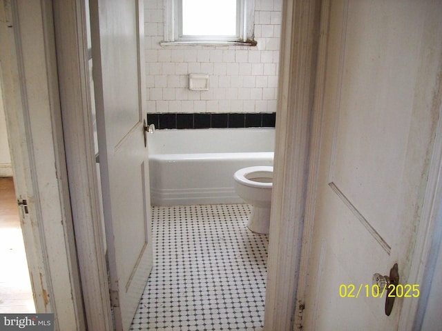 bathroom with tile patterned floors and toilet