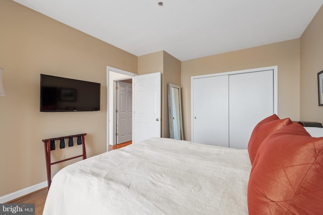 bedroom featuring wood-type flooring and a closet