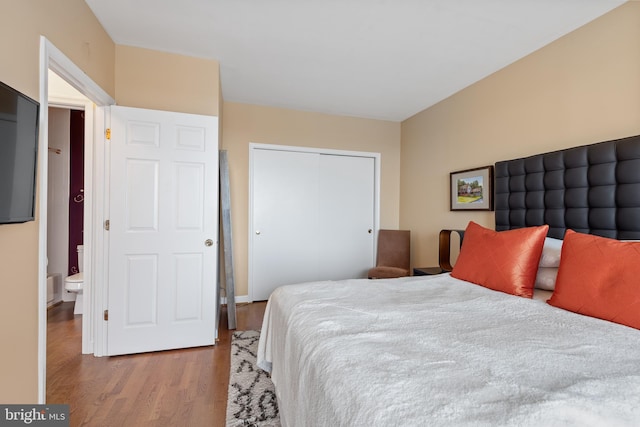 bedroom with light hardwood / wood-style flooring and a closet